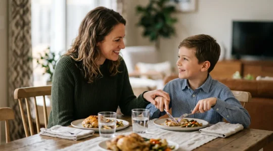 Parent and child practicing polite conversation at a dinner table in a warm home setting