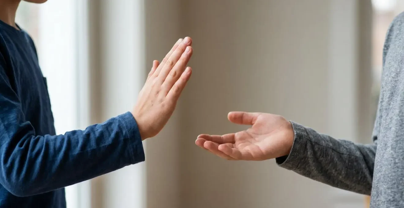 Close-up of a young child's hands gesturing during conversation, symbolizing learning to set boundaries