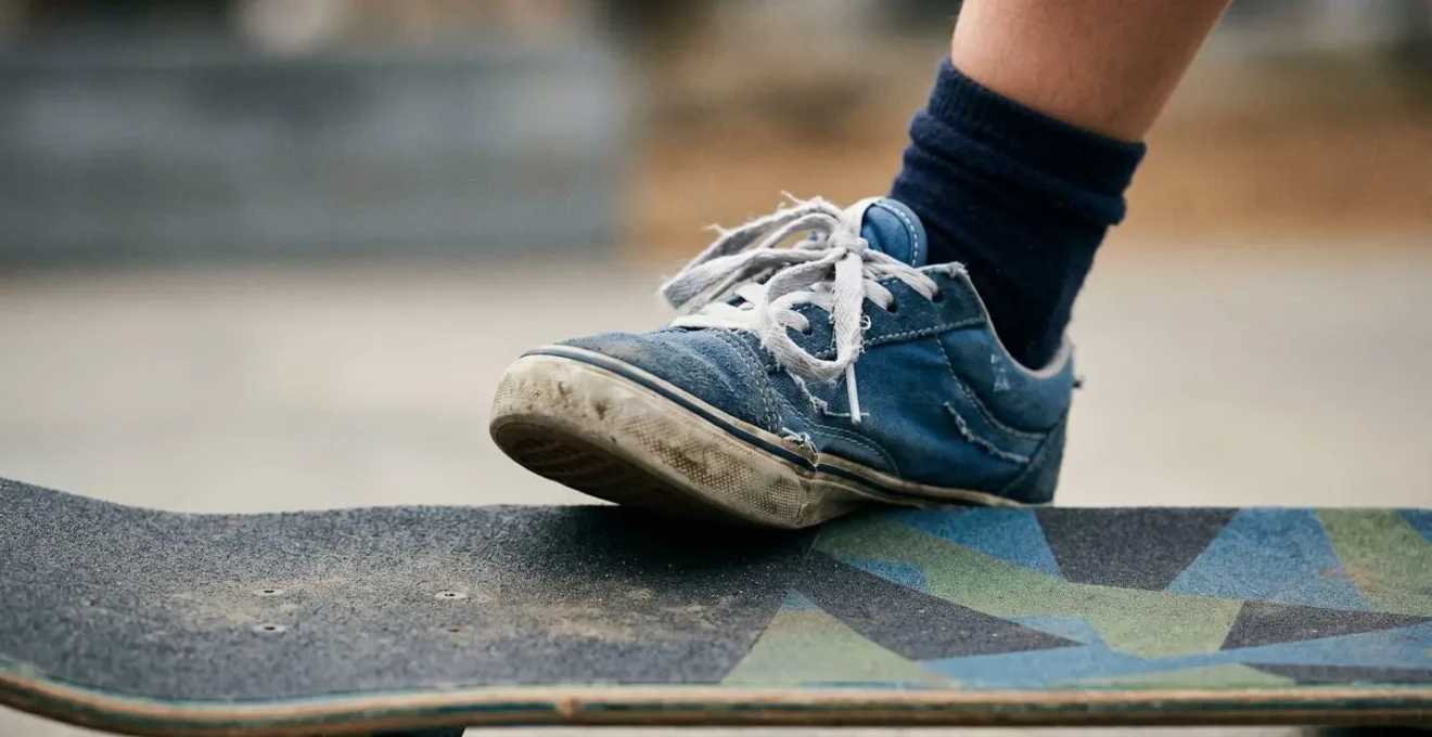 Close-up of child's feet on skateboard showing balance and concentration during practice